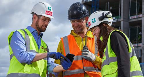 Construction workers using equipment safely