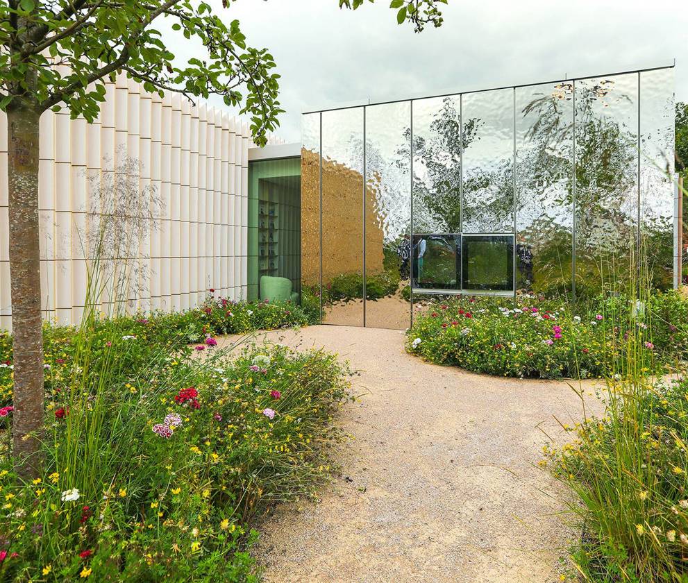 The garden at Maggie’s Southampton, filled with lush greenery, perennials, and trees such as birch, Scots pine, and rowan, creating a tranquil environment