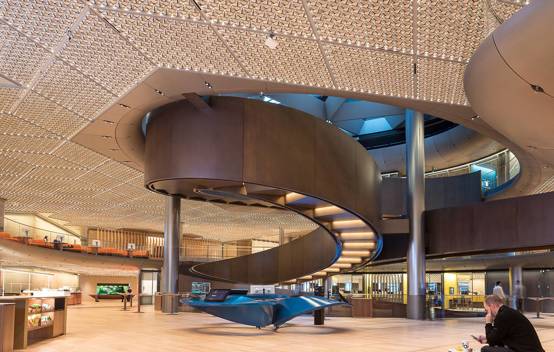 Spacious main lobby of Bloomberg's European HQ, featuring modern design elements and high-end finishes and spiral ramp