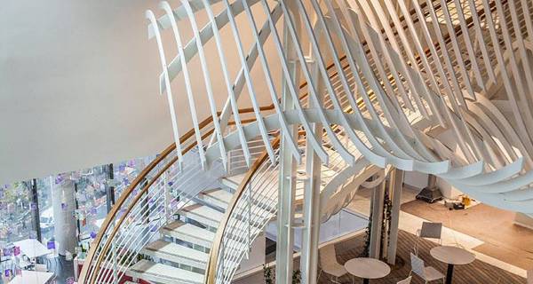 Close-up view of a spiral staircase at the New London Embassy, showcasing its intricate metalwork and elegant design.