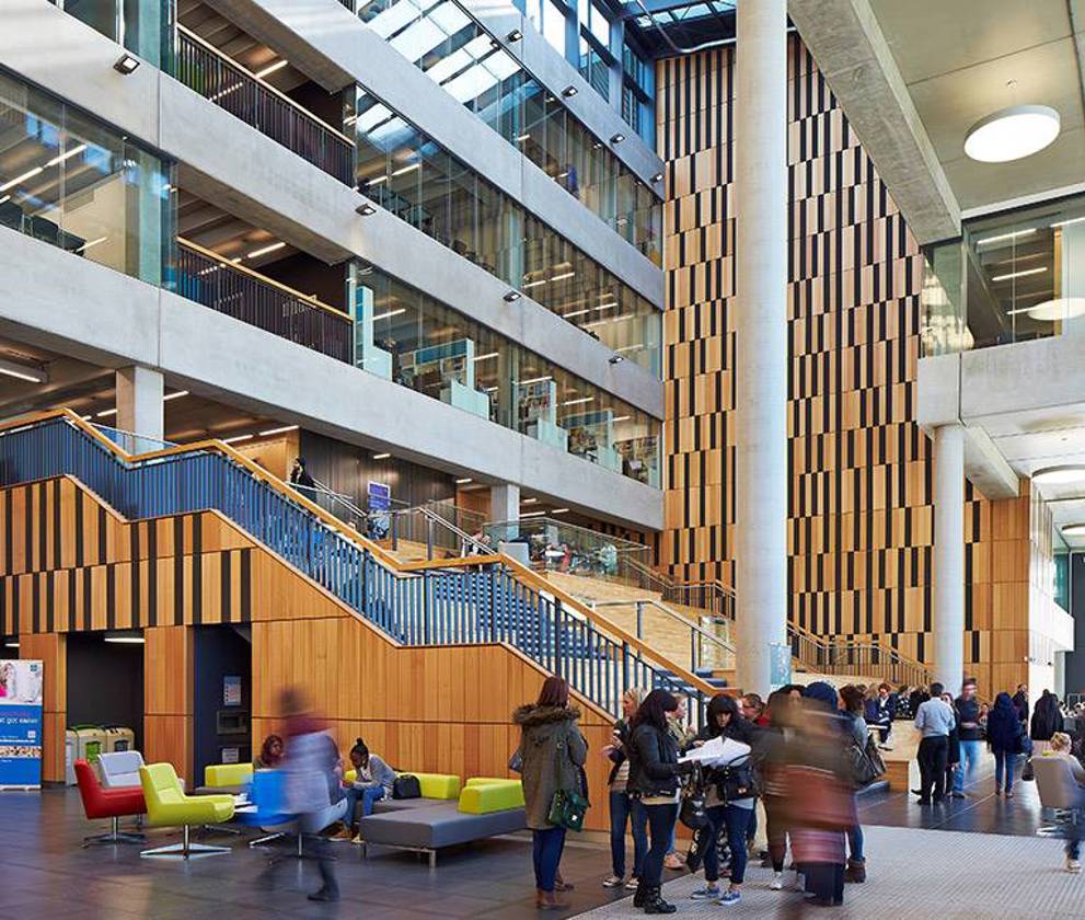 Interior shot of Birley Fields' atrium, with students and staff moving through the spacious, light-filled central area.