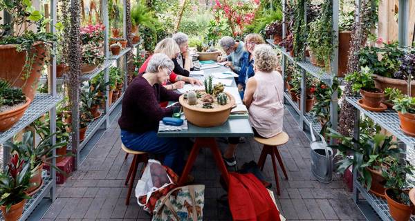 People socialising in Art and Activity Space at Maggie’s at The Christie 