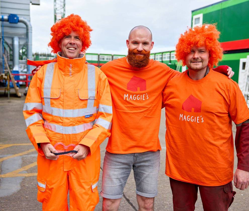 Three man from Kettering  wearing orang Maggies logo T-Shirt 