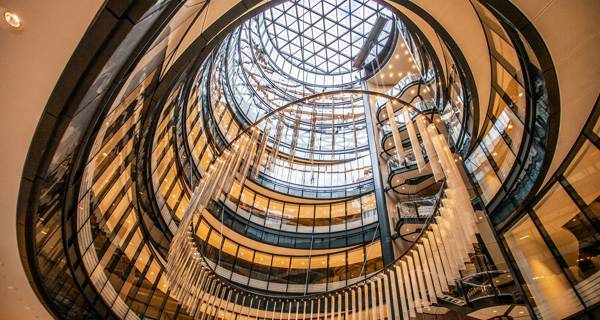 An interior shot of the dramatic atrium and feature staircase within the newly transformed building