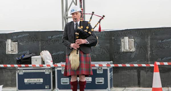 Traditional bag piper at the topping out ceremony