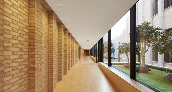 Corridor of De Vere Gardens, featuring marble floors, high ceilings, and modern lighting