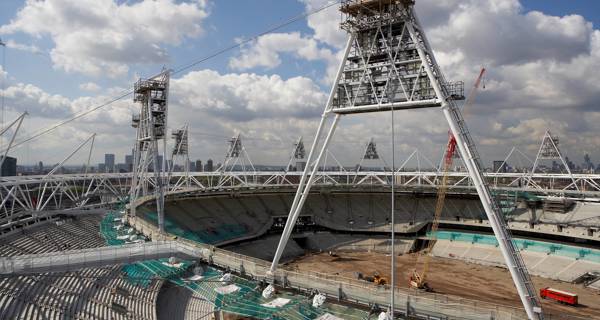 Engineers and construction workers implementing sustainable building practices at the Olympic Stadium