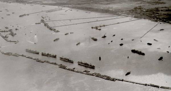  A fleet of tugboats towing the massive concrete caissons across the English Channel from England to Arromanches