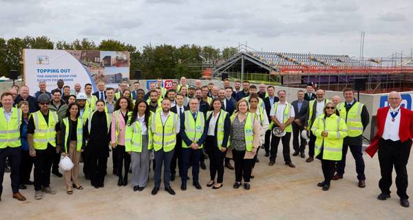 Officials and team members pose for a photo on the rooftop after the ceremony concludes.