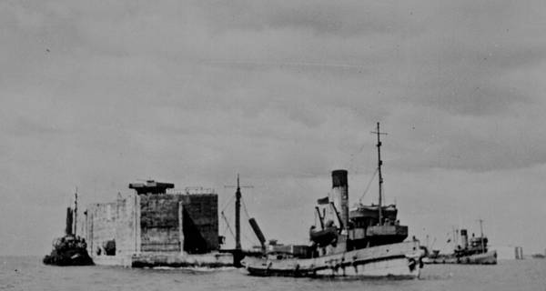 tugboats towing the massive concrete caissons across the English Channel from England to Arromanches