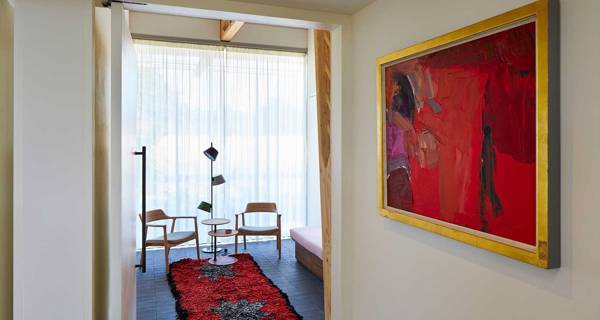 A serene therapy room at Maggie’s at The Christie, furnished with soft chairs, a calming colour palette, and large windows