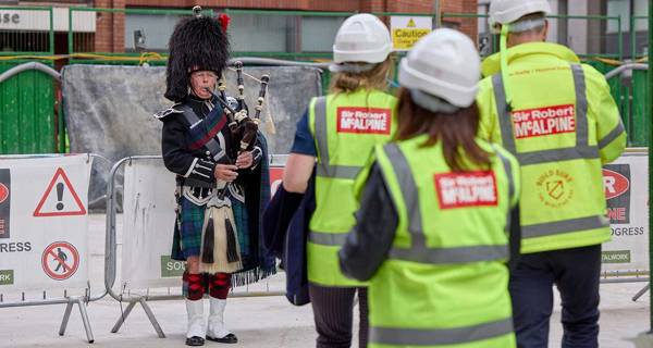 Bagpiper at Morello topping out ceremony 