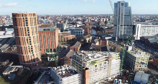 Aerial view of the Mustard Wharf project site, with cranes and other developments in the Holbeck area visible.