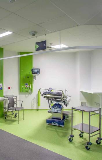 Child-friendly pediatric care area at Chase Farm Hospital, decorated with vibrant colours and equipped with interactive digital tools to comfort young patients.