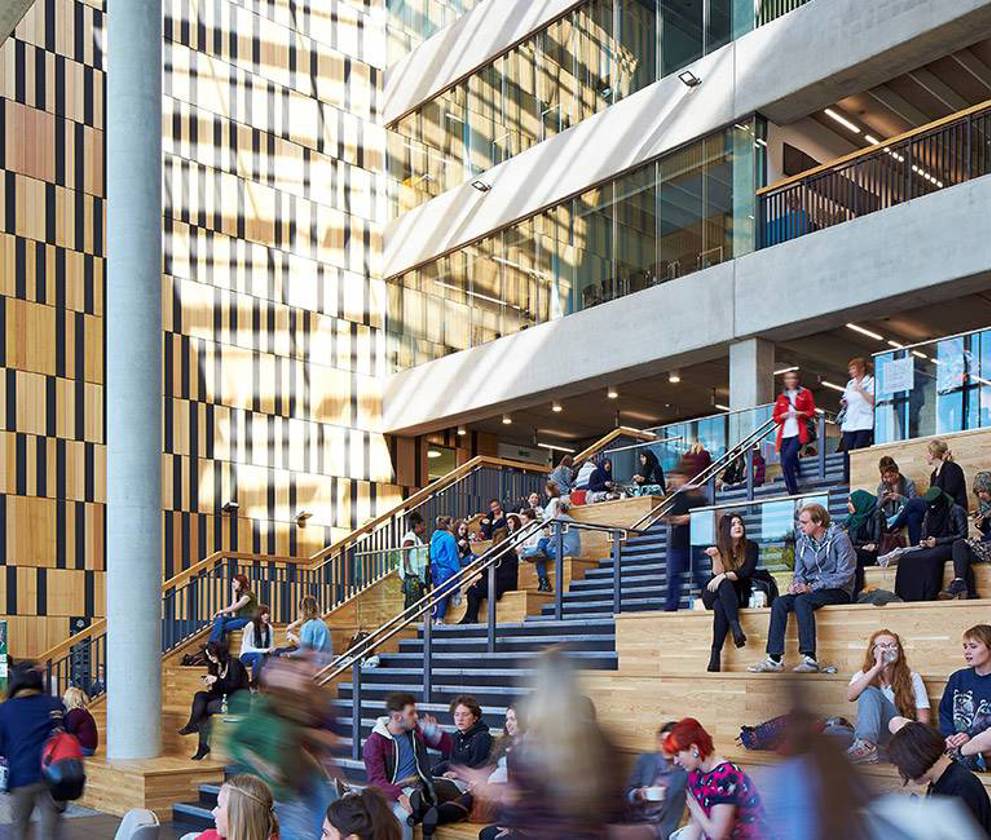 Interior shot of Birley Fields' atrium, with students and staff moving through the spacious, light-filled central area.