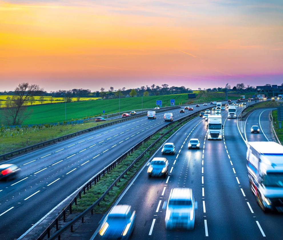 Motorway with traffic at sunset