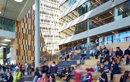 Interior shot of Birley Fields' atrium, with students and staff moving through the spacious, light-filled central area.