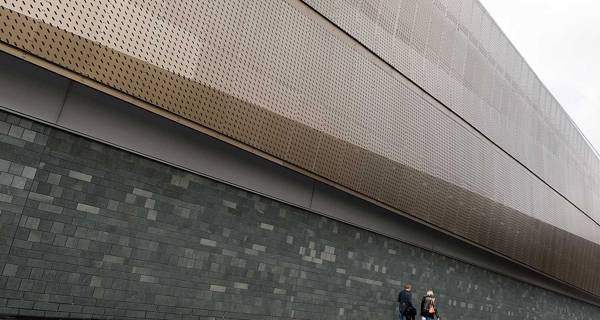 Exterior of Sports Central at Northumbria University with bronze anodized aluminium screens featuring intricate perforations.